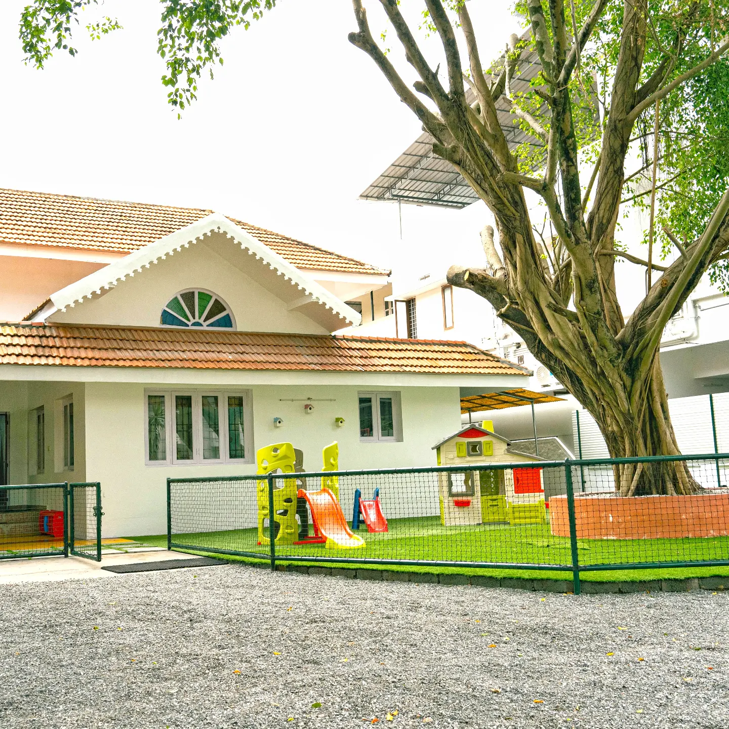 Giggles and Wiggles preschool building with outdoor play area in Thevara, Kochi