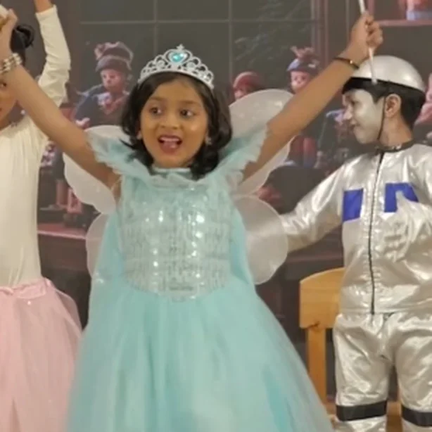 Children performing on stage in fairy costume