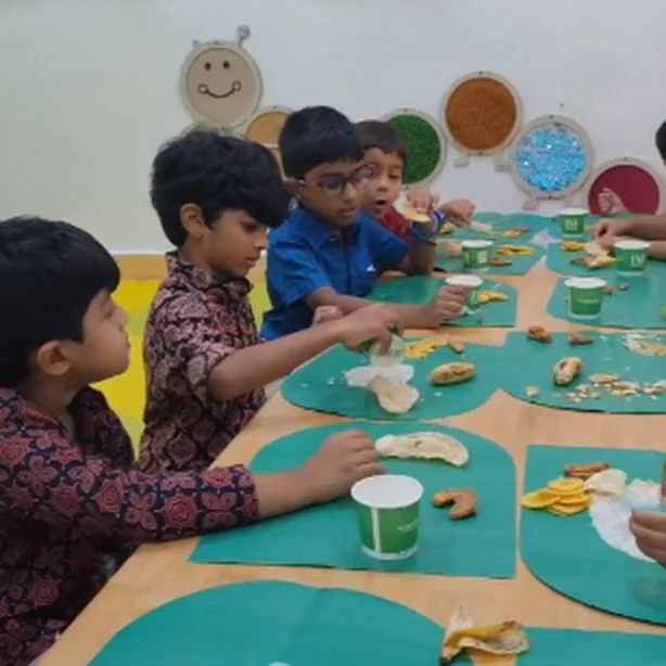 Children sharing a healthy snack around a long table
