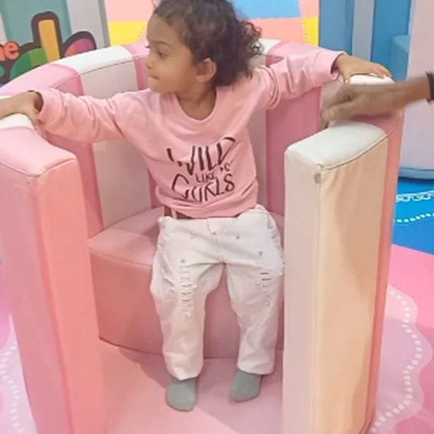 A child playing in our soft pink play corner